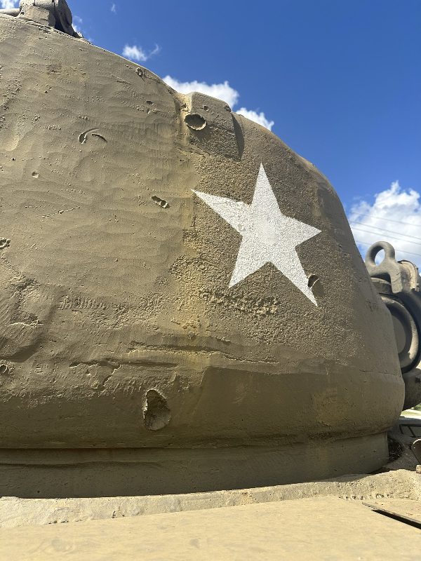 detail of M26 Pershing turret showing battle damage dents in the thick armor